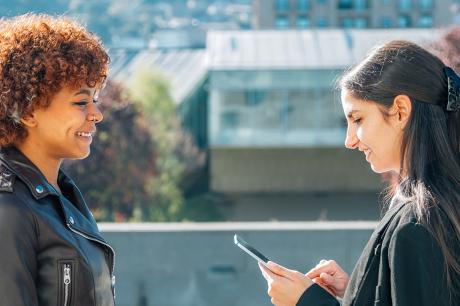 business woman on the street with device interviewing