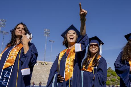 A group of college graduates in their cap and gowns.