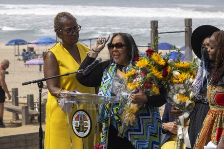  Patricia Bruce-Carter speaks as flowers are presented to some members of the Bruce family at a ceremony to return ownership of Bruce's Beach to the descendants of a Black family who had the land stripped from them nearly a century ago on July 20, 2022 in Manhattan Beach, California