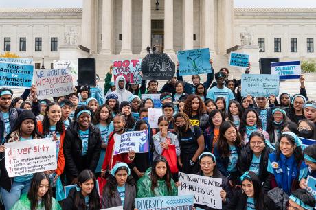 Supporters pose for a group photo during a rally in support affirmative action policies outside the Supreme Court
