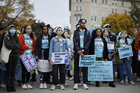 A group of people protesting and marching outside.