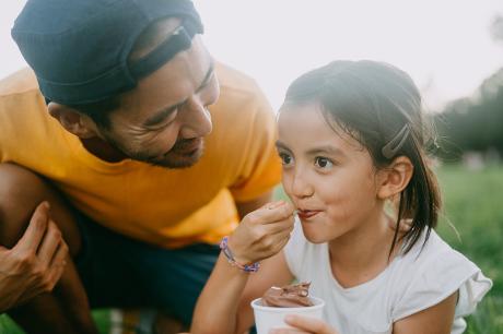 A father and daughter eating ice cream.