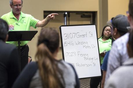 Properties are auctioned off during a foreclosed property sale at the Bayou City Event Center.