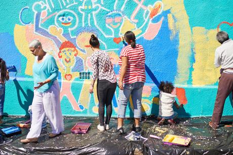 People painting a mural together.