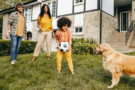 A family playing outside on their lawn.