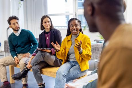 A group of people talking to each other.