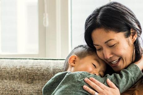 photo of mother hugging son