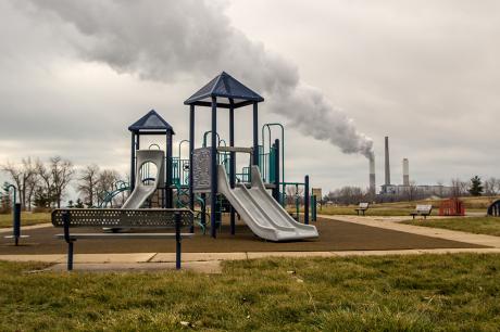 A playground near a factory. 