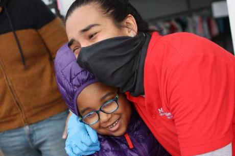 healthworker hugging community member