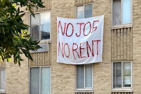 Banners against renters eviction reading "no job, no rent" are displayed on a controlled rent building in Washington, DC
