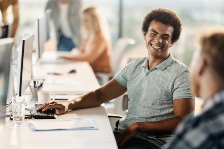 Two people sitting at desks. 