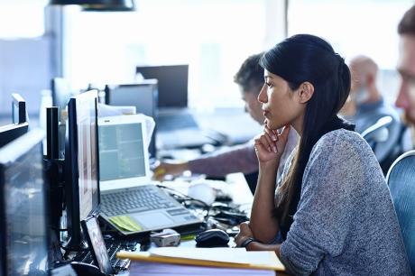 A woman looking at a computer screen.