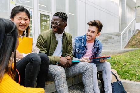 A group of college students talking outside.