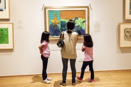 A family looking at a painting inside the National Museum of Mexican Art in Pilsen.