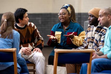 A group of people talking to eachother inside. 