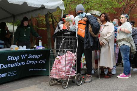 People line up to donate reusable and portable items at an Earth Day Fair in New York, the United States, on April 21, 2023.