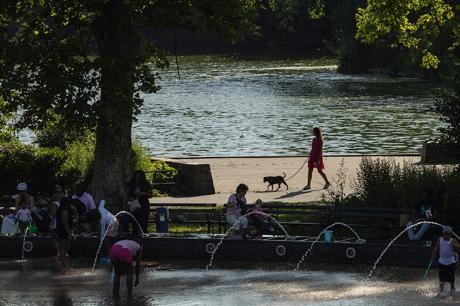 People run across a splash pad at LeFrak Center at Lakeside at Prospect Park in Brooklyn, New York, as a heat wave hits the northeast US on June 20, 2024.