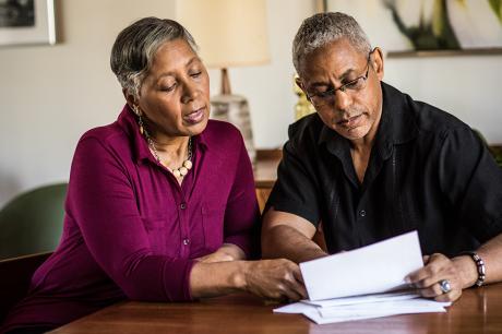 photo of senior couple paying bills at home