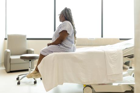 photo of person sitting on hospital bed