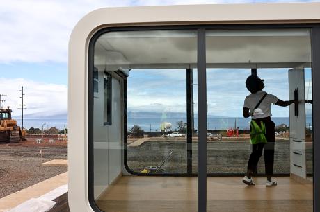 A FEMA official views a modular residential unit at the Ka Lai Ola temporary housing development in Lahaina, Hawaii