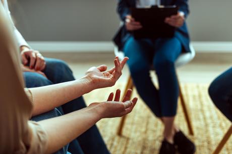 People Attending Support Group Meeting In Community Space