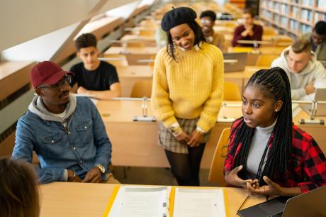 photo of students talking together in a classroom