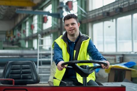 photo of young man with Down syndrome working in industrial factory