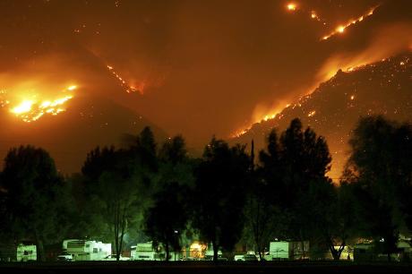 photo of Esperanza Fire burns near trailers before dawn on October 27, 2006 in Banning, California, west of Palm Springs