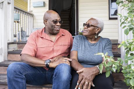 photo of relaxed senior Black couple sitting on front steps
