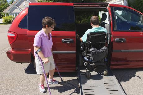 photo of couple with Cerebral Palsy getting into an adaptive vehicle
