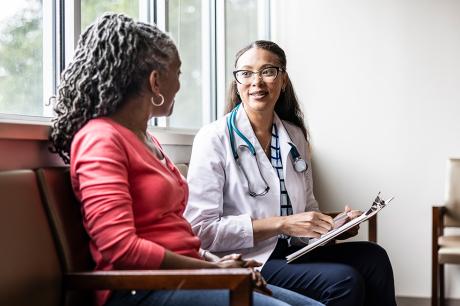 A woman sitting down with her doctor.