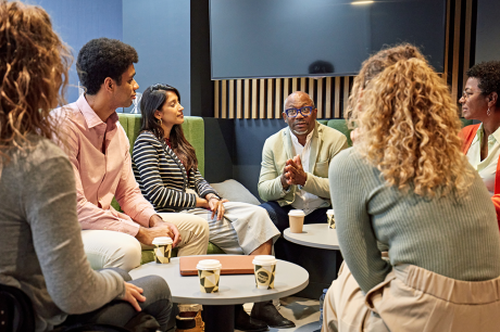 A group of people talking around a circle.