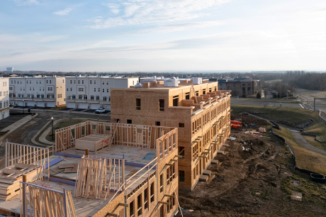 An aerial view of multifamily apartment buildings under construction. 