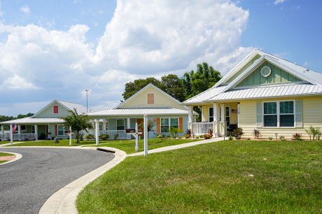 Image of three single family houses with large, lush yards
