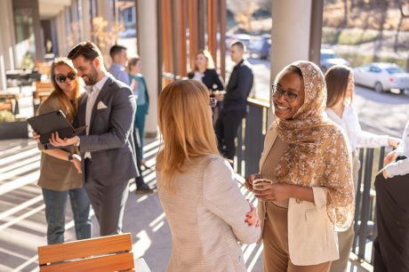 Two women chat at a professional convening.