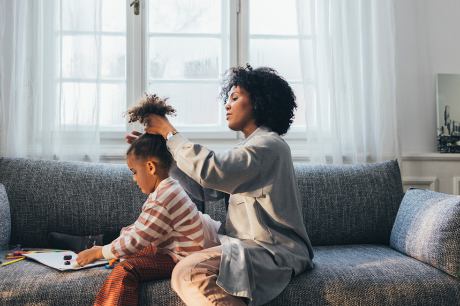 Mother doing her daughter's hair.