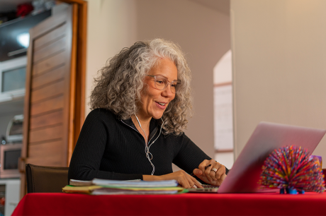 An older woman working on her laptop. 