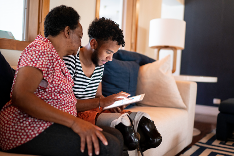 A mother and son sitting on a couch. 