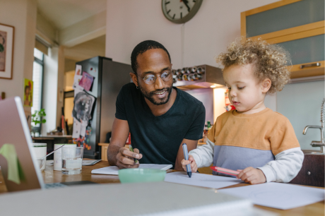 A father and son drawing together.