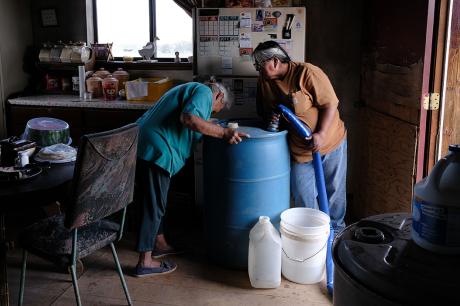A member of the Navajo Nation receives their monthly water delivery