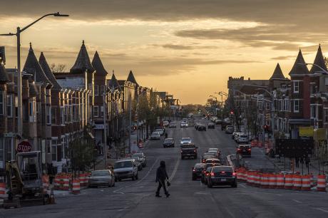 The sun sets over  W. North Avenue in Baltimore, Maryland