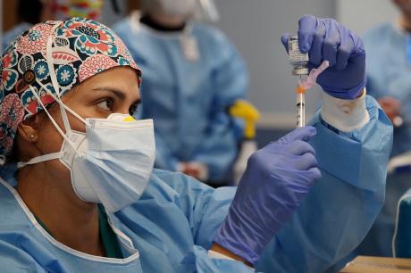 Physician's assistant prepares doses of the Moderna COVID-19 vaccine