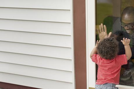 hospital hallway with staff and man pushing a gurney