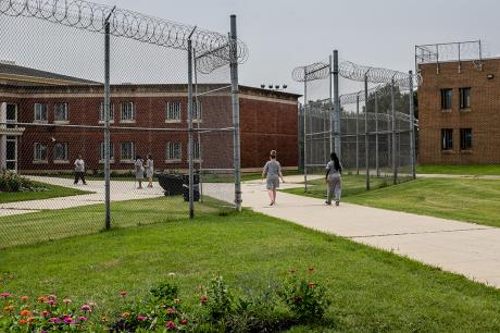 Incarcerated people walk outside a correctional facility