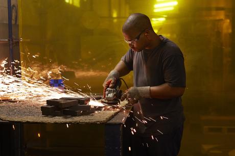 Apprentice uses power tools