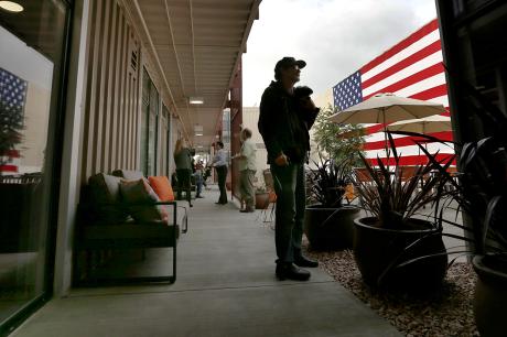 Veteran experiencing homelessness stands with his dog