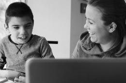Parent tutors their young child with a disability