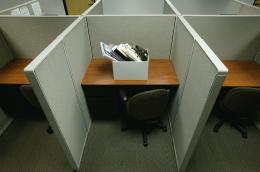 A box full of personal items in a cubicle
