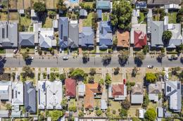 Aerial view of a street with rows of houses on either side