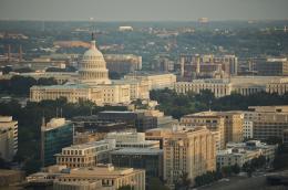 An aerial shot of Washington, DC, featuring the United States Capitol Building and several other structures.